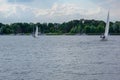 Sailing boat on a calm lake with reflection in the water. Serene scene landscape. Horizontal photograph.