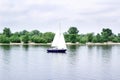 Sailboat yacht team sailing with full sails throught the wind on lake Royalty Free Stock Photo