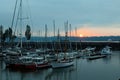 Sailboats anchored in marina and the St. Lawrence River seen during a cloudy summer sunrise