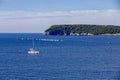 sailboats compete in a sailing regatta, sailboat race, the island is in the background, sunny day, clear weather, intense blue.