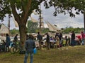 Sailboats fans enjoy big outdoor entertainment event. Open air festival Picnic. Big group of people on grass waiting for armada