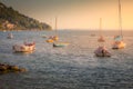 Sailboats floating on Lake Garda at golden sunset, Malcesine, Italy Royalty Free Stock Photo