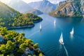 Sailboats gracefully navigating the vast expanse of the tranquil and serene ocean waters