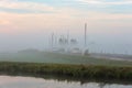 Sailboats and motor yachts moored in a foggy harbor in Warmond Royalty Free Stock Photo