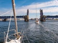 Sailboats passing Limfjord Bridge in Aalborg, Nordjylland, Denmark