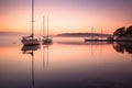 sailboats reflection on calm water at dawn