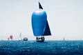 Sailboats during the regatta, front boat with blue sail Royalty Free Stock Photo