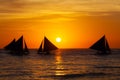 Sailboats at sunset on a tropical sea. Silhouette photo.