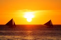 Sailboats at sunset on a tropical sea. Silhouette photo.