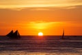 Sailboats at sunset on a tropical sea. Silhouette photo.