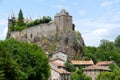 The Sailhant castle on top of a rocky outcrop overlooking the houses of the hamlet Royalty Free Stock Photo