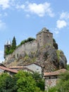 The Sailhant castle on top of a rocky outcrop overlooking the houses of the hamlet Royalty Free Stock Photo
