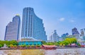 Sailing along the line of modern residential buildings, glass office complexes and high hotels on the bank of Chao Phraya river in Royalty Free Stock Photo