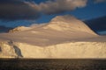 Antarctica calm orange midnight sunset on snowy mountain