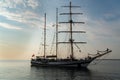 Sailing boat achored on Tallinn bay. 3 mast sailing yacht enjoying the sunset on calm Baltic sea. Beautiful weather and Royalty Free Stock Photo