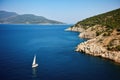 sailing boat approaching a coastline