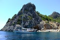 Sailing boat around rocky hills