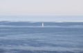 Sailing boat in a blue gradient from the sky to the ocean. It is a beautiful picture of a summer holiday Royalty Free Stock Photo