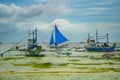 Sailing boat with a blue sail on a background of clouds , Boracay island, Philippines Royalty Free Stock Photo