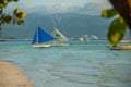 Sailing boat with a blue sail on a background of clouds , Boracay island, Philippines Royalty Free Stock Photo