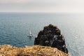 Sailing boat at Cap Frehel cliffs in Brittany