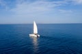 Sailing boat catamaran with white sails, cloudy sky and rippled sea background Royalty Free Stock Photo