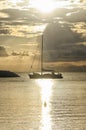 Sailing boat crossing the sun glitter Royalty Free Stock Photo