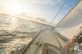 Sailing boat sailing fast into the beautiful sunset during choppy sea with tilted horizon Royalty Free Stock Photo