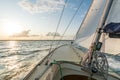 Sailing boat sailing fast into the sunset on choppy sea Royalty Free Stock Photo