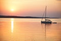 Sailing boat floats in the calm sea at sunrise Royalty Free Stock Photo
