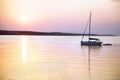 Sailing boat floats in the calm sea at sunrise Royalty Free Stock Photo