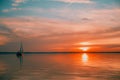 Sailing boat floats on the lake at sunset Royalty Free Stock Photo