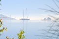 Sailing boat in the misty morning