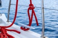 Sailing boat mooring rope tied on cleat, blur sea water background Royalty Free Stock Photo