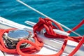 Sailing boat mooring rope tied on cleat. Heavy metal chain around the winch Royalty Free Stock Photo