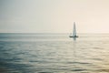 Sailing boat in open sea at sunset. Royalty Free Stock Photo