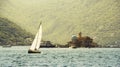 Sailing boat and Gospa od Skrpjela Royalty Free Stock Photo