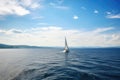 sailing boat, with person at the helm, sailing on azure sea Royalty Free Stock Photo