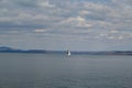 Sailing boat in the sea on a background of blue sky with clouds Royalty Free Stock Photo