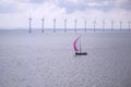 Sailing boat in a sea. Windmills in the sea. Yacht sailing in ocean. Sailing vessel....... Royalty Free Stock Photo