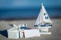 Sailing boat and seashell sand decoration closeup Royalty Free Stock Photo