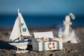 Sailing boat and seashell in sand decoration closeup Royalty Free Stock Photo