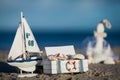 Sailing boat and seashell in sand decoration closeup Royalty Free Stock Photo