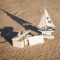 Sailing boat and seashell in sand decoration closeup Royalty Free Stock Photo