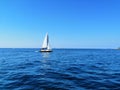 Sailing boat with white sails, sailing on sea, blue sky Royalty Free Stock Photo