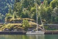 Sailing boat anchored in marina in the deep norwegian fjord. Royalty Free Stock Photo