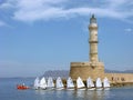 Sailing boats around lighthouse. Greece, Crete, Chania. Royalty Free Stock Photo