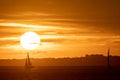 Sailing boats float in the sea at a bright orange sunset Royalty Free Stock Photo