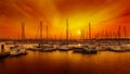 Sailing boats at harbour against orange sunset Royalty Free Stock Photo