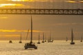 Sailing boats are sailing in the sea by the bridge at orange sunset Royalty Free Stock Photo